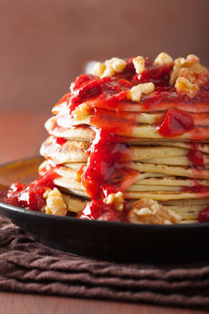 stack of pancakes with strawberry jam and walnuts. tasty dessertの写真素材