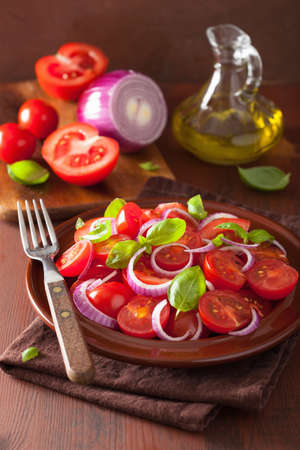 healthy tomato salad with onion basil olive oil and balsamic vinegarの写真素材