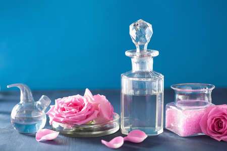 alchemy and aromatherapy with rose flowers and chemical flasks