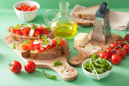 italian bruschetta with tomatoes parmesan arugulaの写真素材