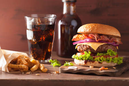 bacon cheese burger with beef patty tomato onion colaの写真素材