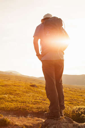 hiker with backpack travelling in Norway mountains Dovre