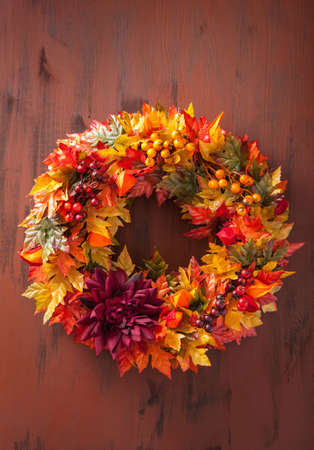 handmade diy artifical autumn wreath decoration with leaves berry flowerの写真素材