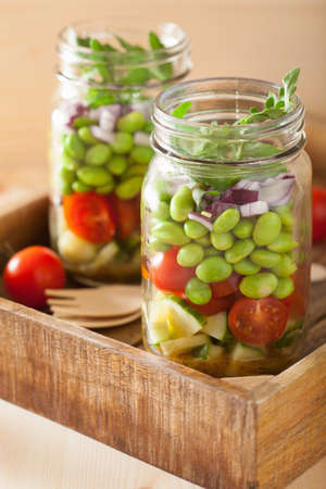 healthy vegetable salad in mason jar: tomato, cucumber, soybean, onionの写真素材