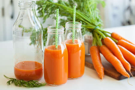 fresh carrot juice and vegetablesの写真素材