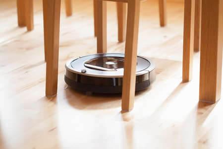 robotic vacuum cleaner on laminate wood floor smart cleaning technology