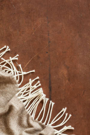 warm wool throw plaid on wooden backgroundの写真素材