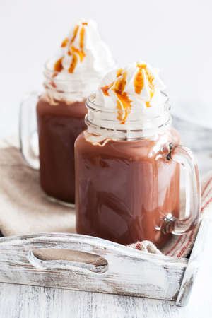 hot chocolate with whipped cream caramel in mason jarの写真素材