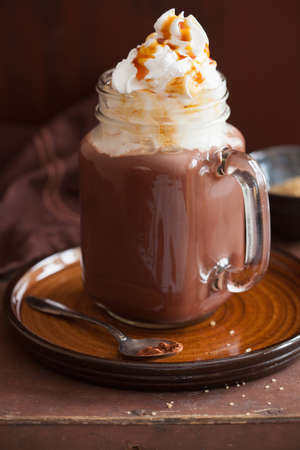 hot chocolate with whipped cream caramel in mason jarの写真素材