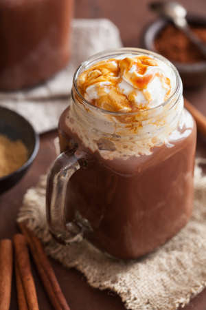 hot chocolate with whipped cream caramel in mason jarの写真素材
