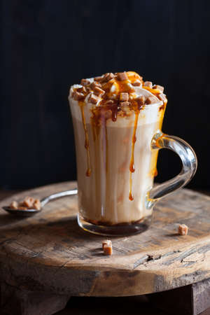 cafe latte with whipped cream and caramelの写真素材