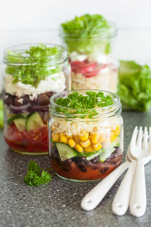 healthy vegetable cheese salad in mason jarsの写真素材