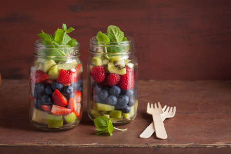 fruit salad in mason jar strawberry blueberry kiwi apple mintの写真素材