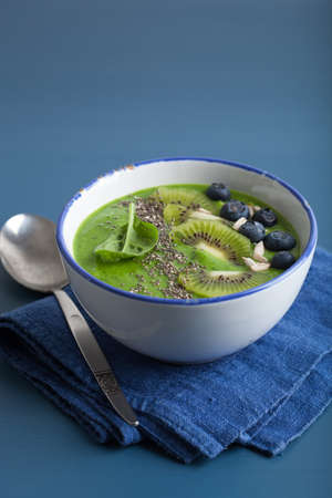 green smoothie bowl spinach kiwi blueberry banana with chia seedの写真素材