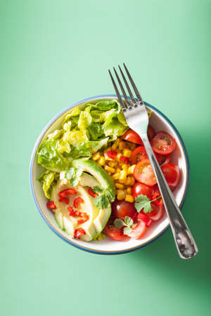 healthy vegan avocado salad with tomatoes and sweetcornの写真素材