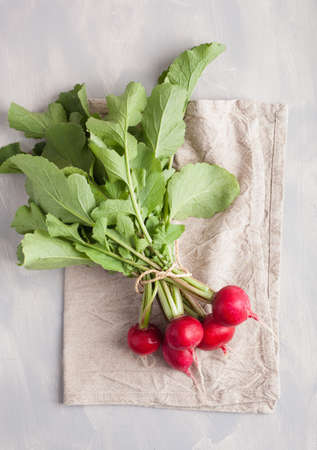 fresh raw radish with leaves over gray backgroundの写真素材