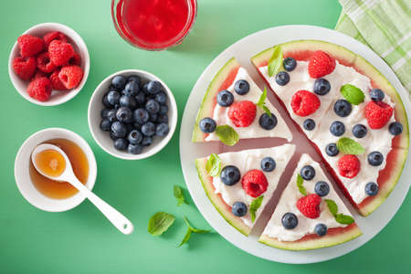 watermelon pizza slices with yogurt and berries, summer dessertの写真素材