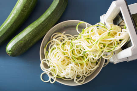 spiralizing courgette raw vegetable with spiralizerの写真素材