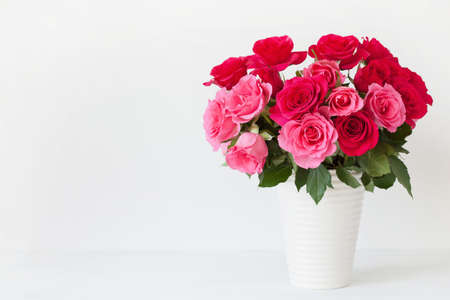 beautiful red rose flowers bouquet in vase over whiteの写真素材