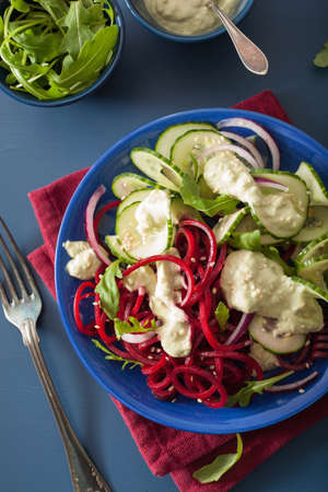 spiralized beet and cucumber salad with avocado dressing, healthy vegan mealの写真素材