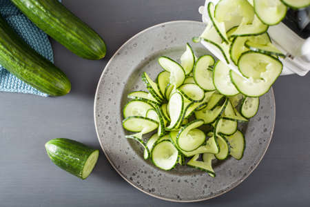 spiralizing cucumber vegetable with spiralizerの写真素材