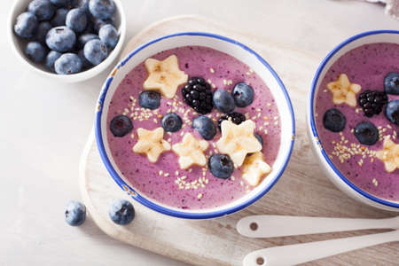 healthy berry smoothie bowl with banana and sesame seedの写真素材