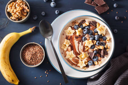 healthy banana smoothie bowl with blueberry chocolate walnutsの写真素材