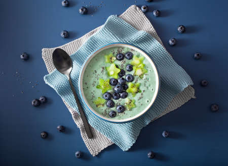 healthy spirulina smoothie bowl with blueberry, kiwi stars, chia seedの写真素材