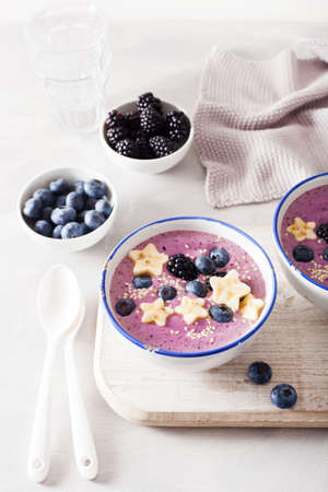 healthy berry smoothie bowl with banana and sesame seedの写真素材