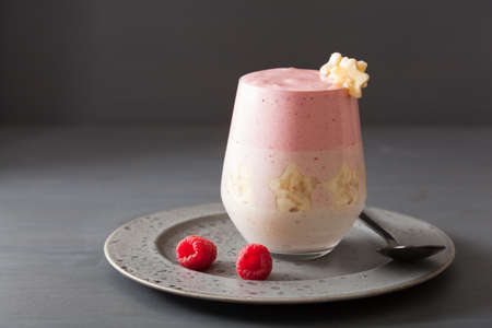 healthy layered raspberry banana smoothie in glass
