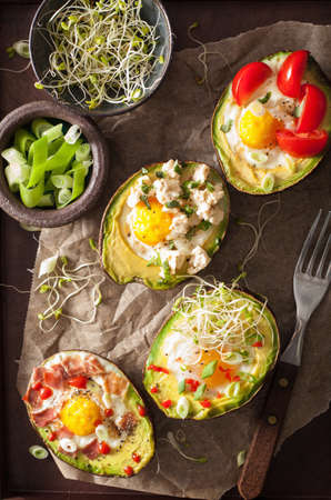 eggs baked in avocado with bacon, cheese, tomato and alfalfa sprouts