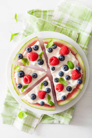 watermelon pizza slices with yogurt and berries, summer dessertの写真素材