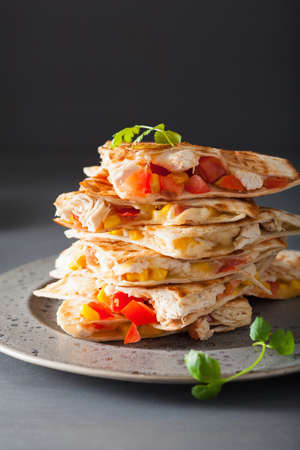 mexican quesadilla with chicken, tomato, sweet corn and cheeseの写真素材