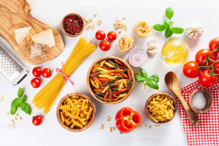 ingredients for italian cousine flat lay, pasta spaghetti penne fusilli tomato oil vegetablesの写真素材