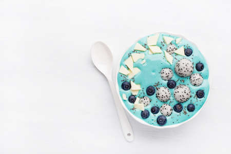 healthy blue spirulina smoothie bowl with blueberry, white chocolate, dragon fruit, chia seedの写真素材