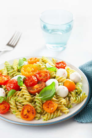 Healthy fusilli pasta with pesto sauce, roasted tomatoes, mozzarellaの写真素材