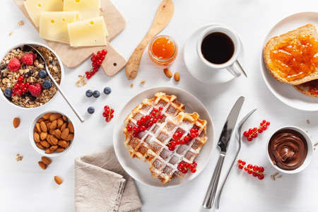 breakfast granola berry nuts, waffle, toast, jam, chocolate spread and coffee. Top viewの写真素材