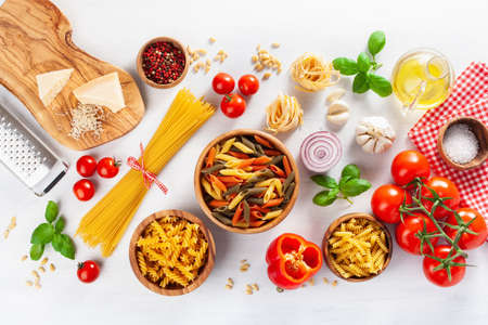 ingredients for italian cousine flat lay, pasta spaghetti penne fusilli tomato oil vegetablesの写真素材