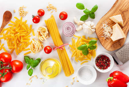 ingredients for italian cousine flat lay, pasta spaghetti penne fusilli tomato oil vegetablesの写真素材