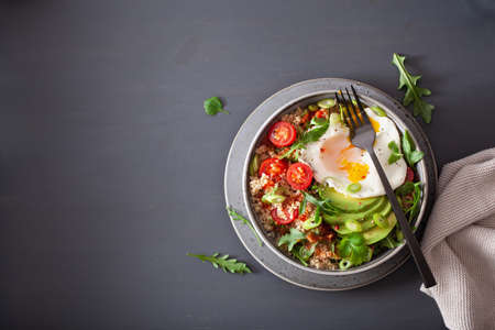 quinoa bowl with fried egg, avocado, tomato, rocket. Healthy vegetarian lunchの写真素材