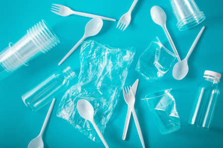 single use plastic cups, forks, spoons, bottles. concept of recycling plastic, plastic wasteの写真素材