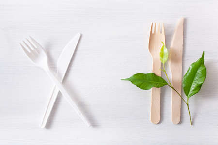 harmful plastic cutlery and eco friendly wooden cutlery. plastic free conceptの写真素材