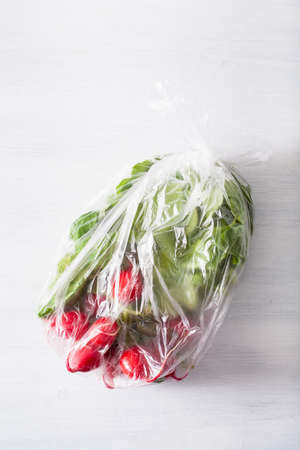single use plastic packaging issue. fruits and vegetables in plastic bagの写真素材