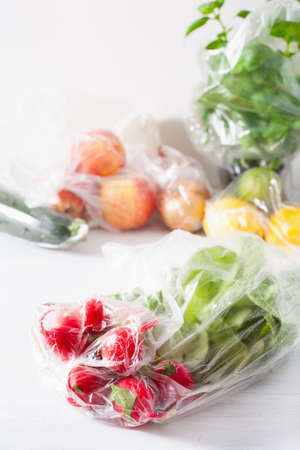 single use plastic waste issue. fruits and vegetables in plastic bagsの写真素材