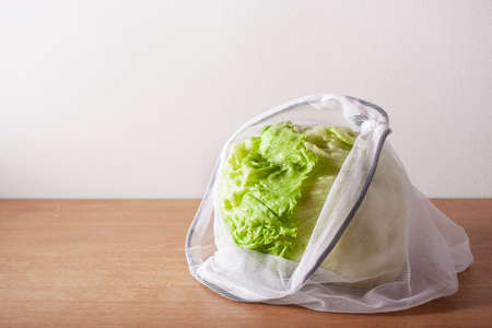lettuce in reusable mesh nylon bag, plastic free zero waste concept