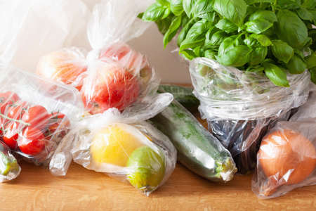 single use plastic waste issue. fruits and vegetables in plastic bagsの写真素材
