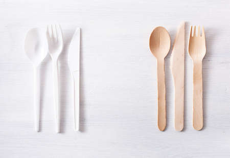 harmful plastic cutlery and eco friendly wooden cutlery. plastic free concept