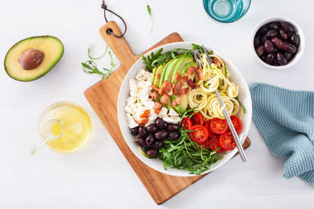 ketogenic lunch bowl: spiralized courgette with avocado, tomato, feta cheese, olives, baconの写真素材