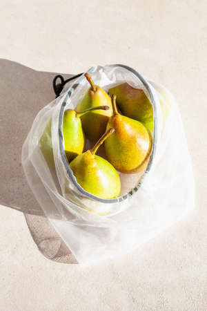 pears fruits in reusable mesh nylon bag, plastic free zero waste conceptの写真素材
