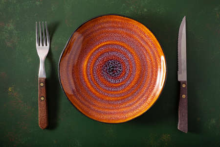 empty plate fork knife on concrete backgroundの写真素材